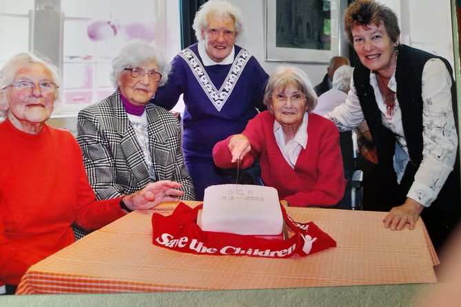 Members of the branch cut a cake 