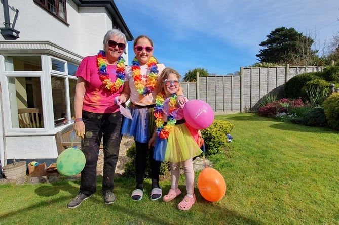 Elaine, Mia and Mollie are pictured getting ready for the Colour Run Remix with a paint party in their garden over Easter weekend
