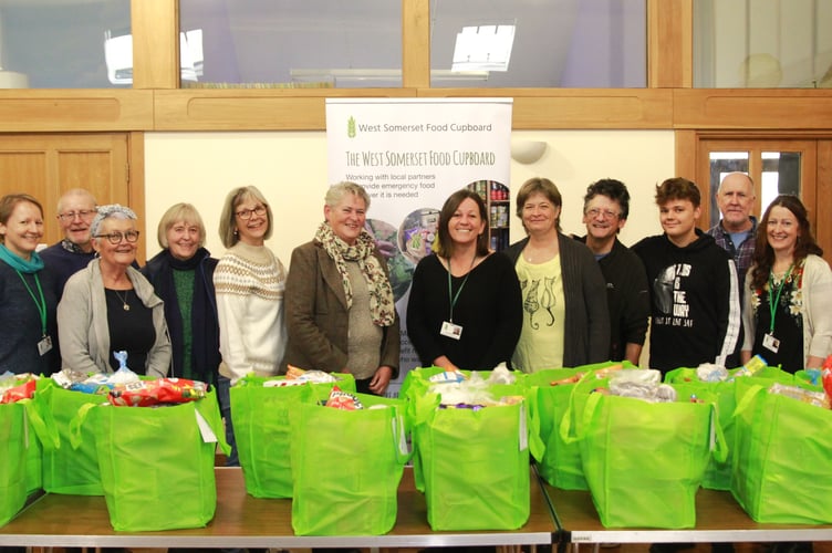 West Somerset Food Cupboard volunteers (left to right) Tracey Roberts, Lyn Edwards, Lyn Edwards (same name), Jane Jones, Lynda Flatley, Katrina Midgeley, Ali Sanderson, Kate Ross, Tim Bosley, Ashton Lamb, Michael Flatley, and Cathy Elston.