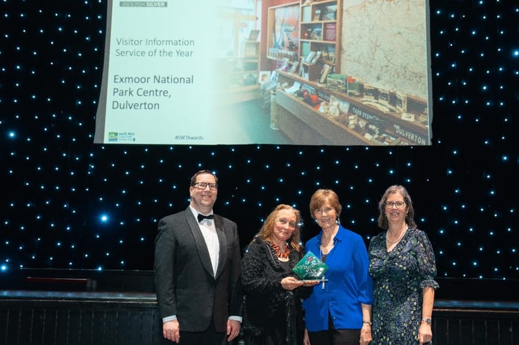 Dan James - Enterprise and Communications Manager, Anne Brice - Centre Manager, and Shelley Trace - Information Advisor, receive the Award from Hilary Dinsdale of Award sponsor the South West Coast Path Association. 