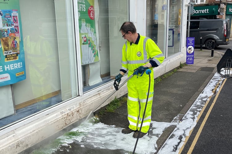 Controlling weeds in The Parade, Minehead, with a new product being trialled by the town council. 