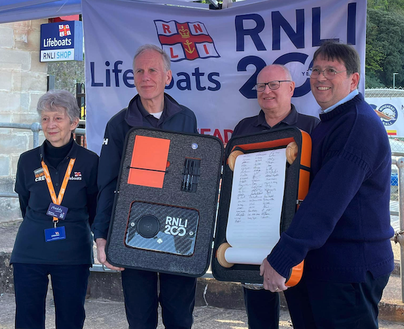 Pictured with the RNLI 200th commemorative scroll at Minehead Lifeboat Station are (left to right) fund-raising volunteer Maddy Taylor, lifeboat operations manager John Higgie, shop volunteer Phil Pegg, and station chairman Richard Newton.