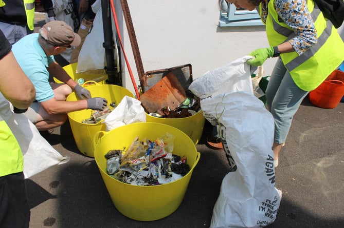Some of the rubbish collected by a Plastic Free Watchet beach clean is sorted by volunteers.