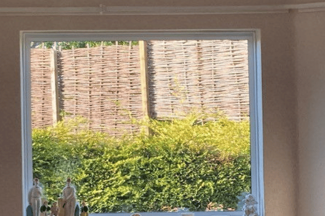 A West Somerset man has been ordered to take down fences which 'blocked' a neighbour's view from their window