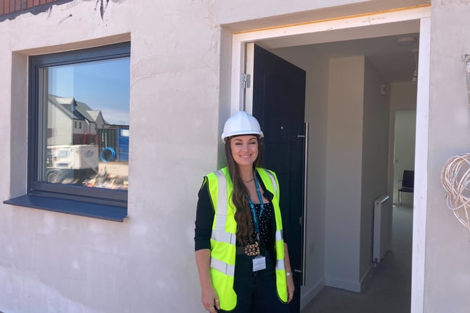 Somerset Council project officer Alex Williams outside one of the new council houses on Rainbow Way in Minehead (Daniel Mumby)