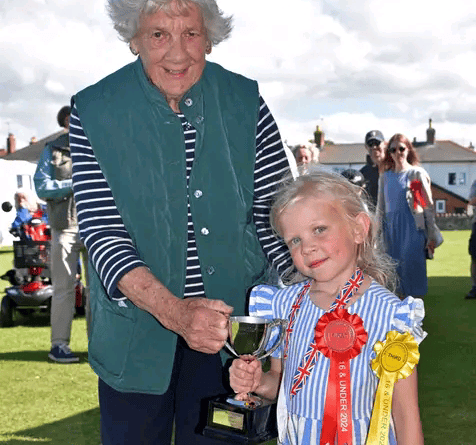 Val Norman donated a trophy to Watchet Gardening Club in memory of her late husband Keith and presented it to the children's 'Best in Show' winner Tilly Jukes. PHOTO: Peter Mather.