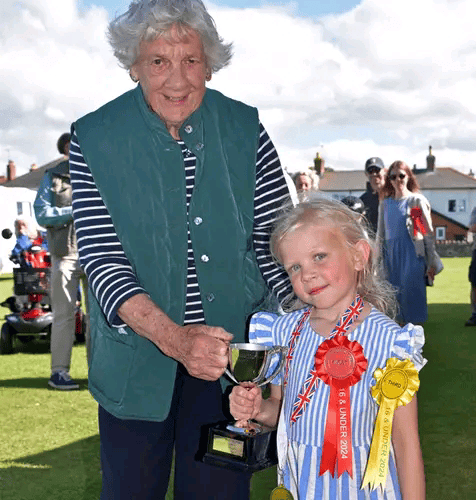 Val Norman donated a trophy to Watchet Gardening Club in memory of her late husband Keith and presented it to the children's 'Best in Show' winner Tilly Jukes. PHOTO: Peter Mather.