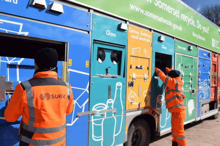 Recycling being loaded into Suez lorries by a Somerset Waste Partnership employee