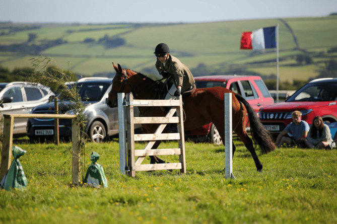 A young rider grapples with a gate