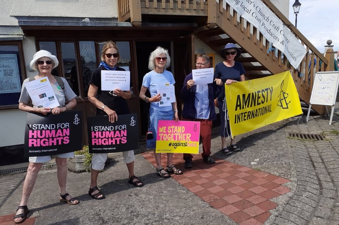 members of the Minehead Amnesty International Group held a vigil outside St Peter’s Chapel on Minehead quay