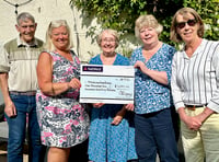 Town's 'secret gardeners' give cheque to food bank