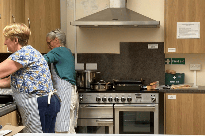 Volunteer cooks prepare a meal for Stogursey Lunches when the group still used the vllage's Church Rooms.