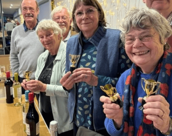 Winning quiz team, the Optimists, with their prizes and trophies