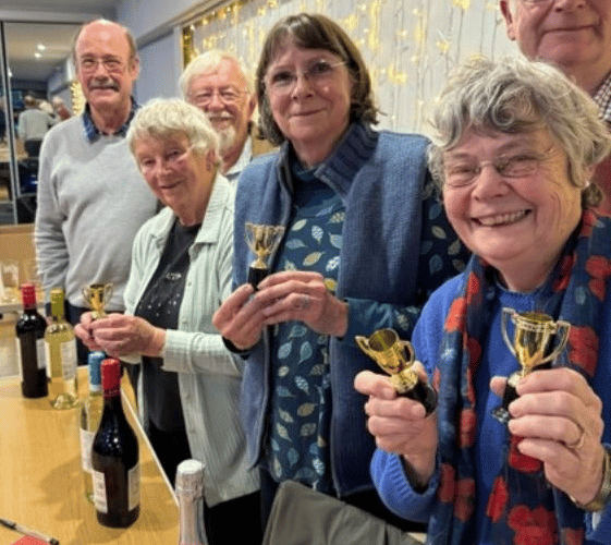 Winning quiz team, the Optimists, with their prizes and trophies