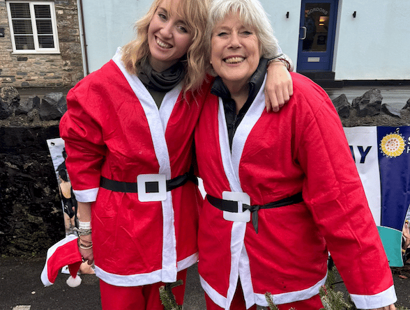 Sam Westmacott (right) and Marika Mossman in their Santa outfits prepare for a Cheddar Gorge charity abseil event.