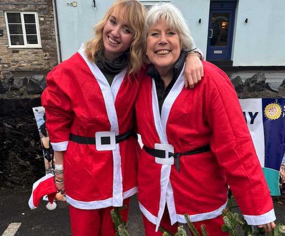 Sam Westmacott (right) and Marika Mossman in their Santa outfits prepare for a Cheddar Gorge charity abseil event.