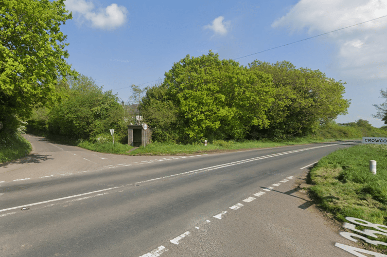 The A358 has been closed after a lorry crashed off the road