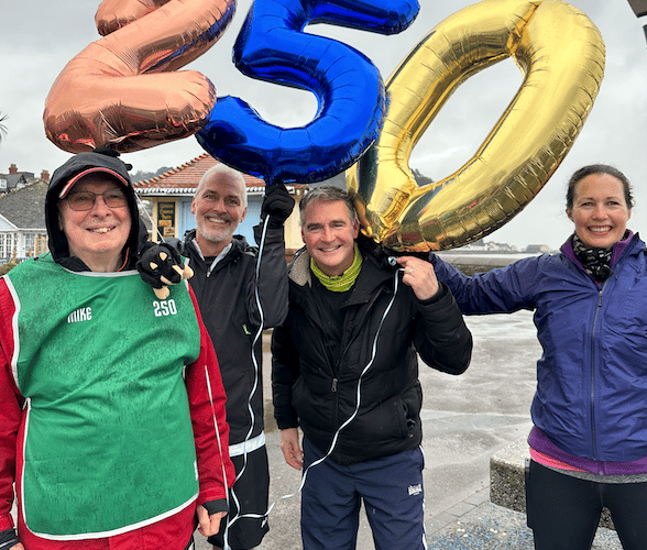 Mike Capel (front) celebrates 250 Minehead Parkrun events with his sons Jon and Marcus and family friend Jennie Norris.