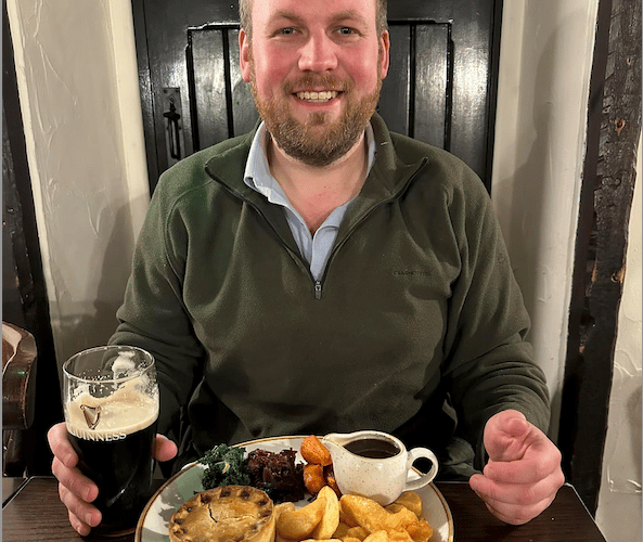 Exmoor campaigner James Wright with a pint and a pub meal in the Royal Oak, Winsford.